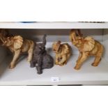 Shelf of Resin Elephant figures .