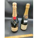 Bottle of champagne together with bottle of Moët.