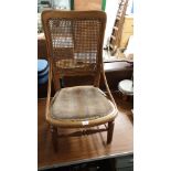 Antique unusual rattan arm chair with a bentwood design arms..