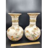 Large pair of japenese porcelain vases with bird foliage signed to the base .