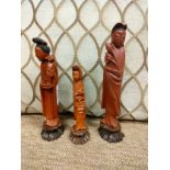 3 oriental figures satup on plinths .