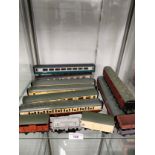 Shelf of 00 gauge coaches wagons etc .