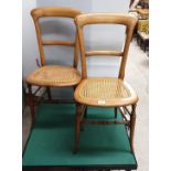 Pair of antique rattan based chairs with turned supports .