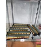 Shelf of 00 gauge coaches etc .