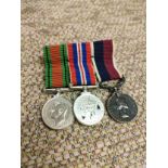 World war 2 miniature medals on small bar .