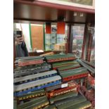 Shelf of train carriages includes oo gauge .