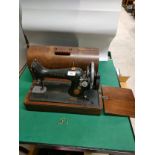 1900s singer sewing machine with casing and key .