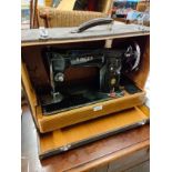 Singer sewing machine in fitted original casing .