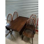 Ercol dark wood elm wood table with 4 Ercol chairs .