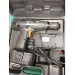 Cordless hammer drill in fitted case .