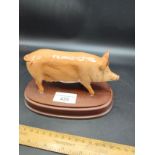 Beswick pig figure on plinth.