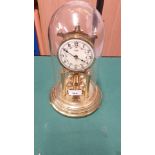 Vintage brass clock with enamel face with 4 ball revolving pendulum. Working order .