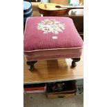 1900s Queen Anne legged stool with burgendy background and flower design .