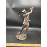 Vintage bronzed style golfing figure teeing off .