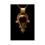 ROMAN GOLD AND GARNET PENDANT