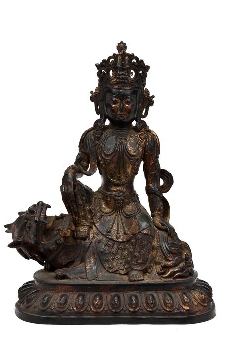 A sizable Sino Tibetan, Laquered and gilt Statue of Guan Yin sitting on a Snow Lion