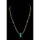 AN ANCIENT EGYPTIAN FAIENCE NECKLACE WITH PATAIKOS AMULET