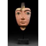 AN ANCIENT EGYPTIAN GESSO-PAINTED WOOD MUMMY MASK