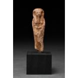 AN ANCIENT EGYPTIAN WAX SHABTI INSCRIBED FOR IRT HOR RERU