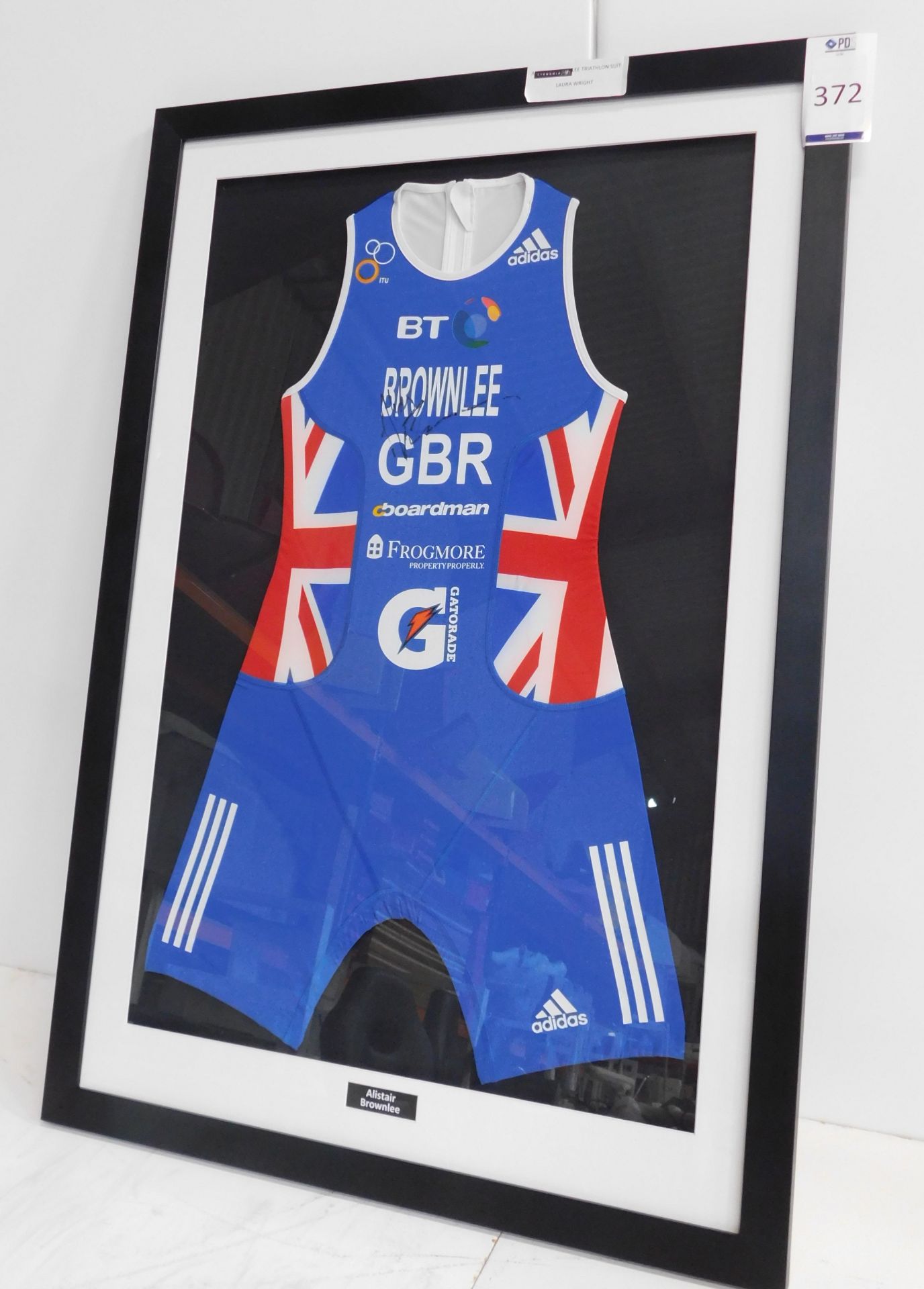 Framed & Signed Alistair Brownlee Triathlon Suit (Overall size: 105cm x 73cm) (Located: Brentwood.