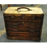 Small pine artisans cabinet with lift lid above an arrangement of seven drawers, originally having a