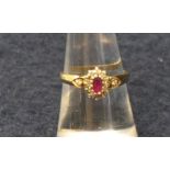 9ct gold oval ruby and diamond cluster ring, size N. Approx weight 2.2g. (B.P. 21% + VAT)