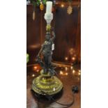 Classically styled brass and spelter figural table lamp with circular repousse base and column in