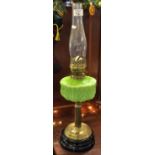 Early 20th Century brass double burner oil lamp with repousse coloured glass reservoir on brass