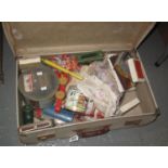 Vintage suitcase containing assorted toys and other oddments to include; vintage cards, wooden