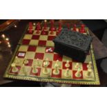 A set of late 19th Century Staunton ivory and red stained ivory chess men in a gothic design