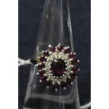 18ct gold ruby and diamond cluster ring. Size K. Approx weight 5.7g. (B.P. 21% + VAT)
