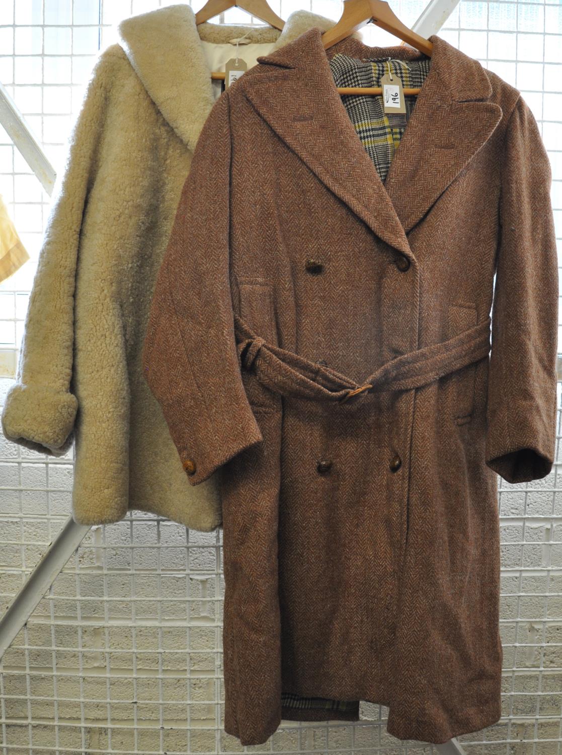 Two vintage coats, one cream sheepskin with shell buttons labelled 'Morlands curlem' and a belted