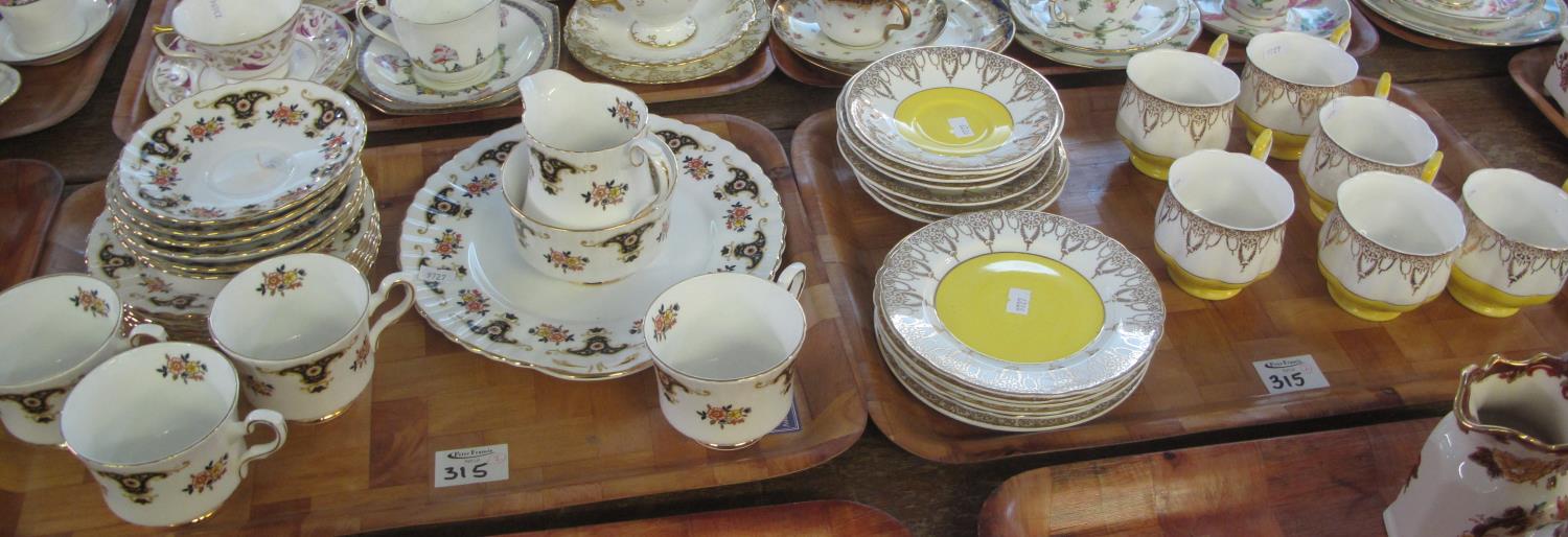 An 18 piece Kevin pottery bone china teaset on a yellow and white gilded ground, together with a