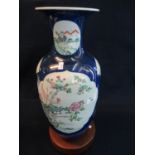 Late Qing Chinese porcelain baluster vase, decorated with famille rose enamels in cartouches, on a