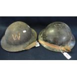 World War II wardens tin helmet, together with another similar. (2) (B.P. 21% + VAT)