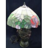 Tiffany style floral table lamp, the base with bronzed finish, classical moulded semi-nude figurines