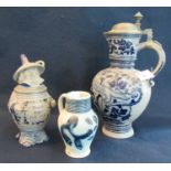 Three items of German stoneware pottery to include; a baluster foliate jug or pitcher with pewter