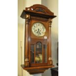 Mid Century mahogany two train wall clock with silvered face, key and pendulum. (B.P. 21% + VAT)