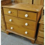 Victorian pine straight front chest of two short and two long drawers with white ceramic turned