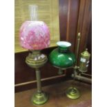 Early 20th century double oil burner having a clear glass chimney, ruby coloured glass shade,