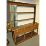 Early 19th Century oak two stage pot board dresser, having moulded cornice above open back with