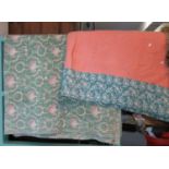 Two vintage cotton quilts, one floral and the other pink/green reversible with patterned edging. (2)