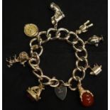 9ct gold charm bracelet with padlock clasp and eight charms. Weight approx 75.5 grams (B.P. 21% +