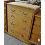 Natural pine straight front chest of four long drawers with metal loop handles on a projected