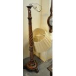 Modern hardwood standard lamp having acanthus leaf and spiral decoration, standing on three feet,