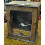 Edwardian oak smokers cabinet, the interior revealing two clay pipes. (B.P. 21% + VAT)