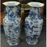 A pair of modern Chinese blue and white vases of hexagonal form, decorated with dragons and