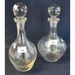 Two similar clear glass mallet shaped decanters and stoppers, unmarked. (2) (B.P. 21% + VAT)
