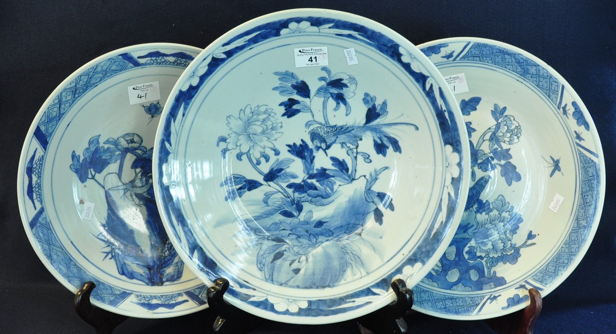 Three early 20th Century Japanese porcelain blue and white chargers decorated with flowers,