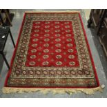 Red ground full pile Kashmir rug with Bokhara design, 170 x 120cm approx. (B.P. 21% + VAT)